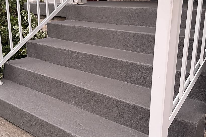Front steps finished with a grey concrete coating